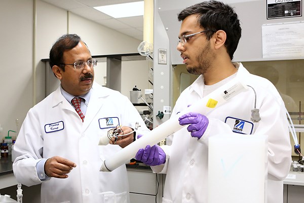 Prof. Pradeep Kurup and geotechnical engineering Ph.D. student Susom Dutta examine a prototype of the electronic “tongue” probe 