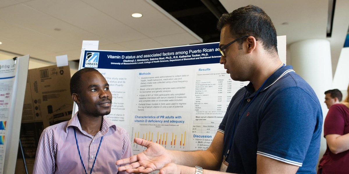Two men standing in front of presentation board during 2018 Student Research Symposium