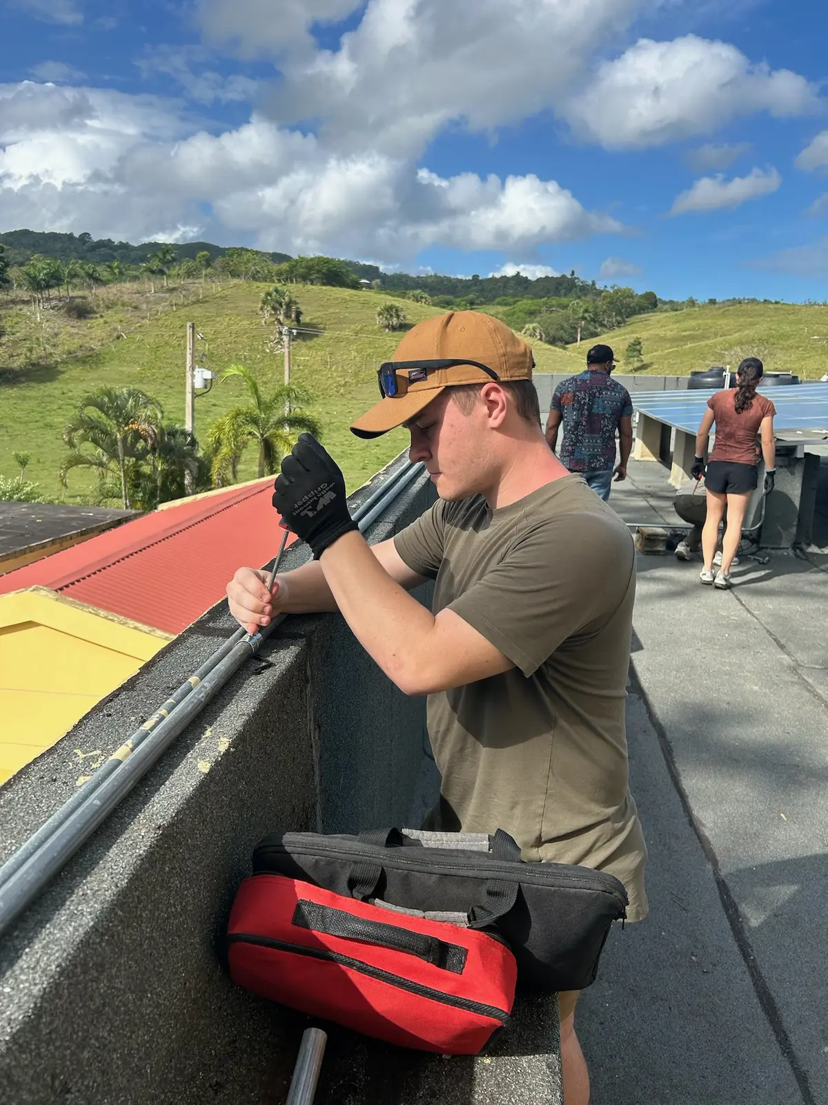 Jacob Hoffman assists with a solar power installation.