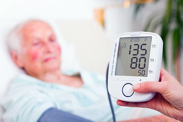 Patient with blood-pressure monitor