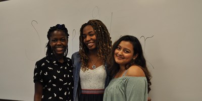 Three women of color in front of white board at RAMP Program