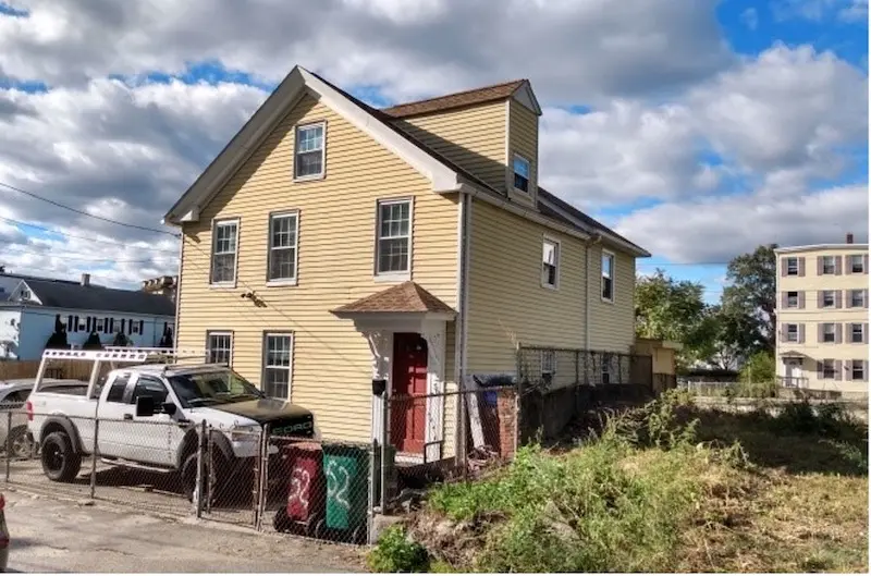 Exterior Federal style home with gable roof and a single gable roof dormer.