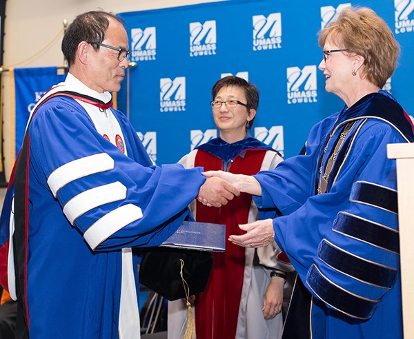 Nobel laureate Suji Nakamura receives an honorary degree from UMass Lowell Chancellor Jacquie Moloney.