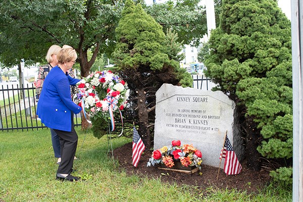 Chancellor Moloney lays a wreath at a granite memorial