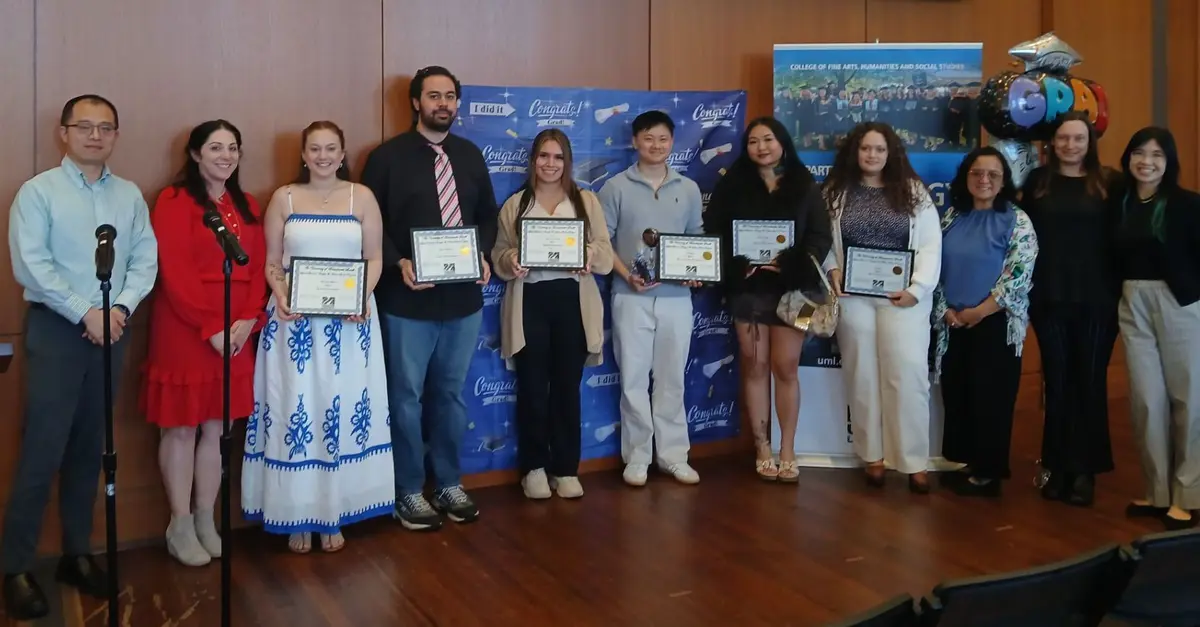 11 students in the ABAAS program hold up their certificates