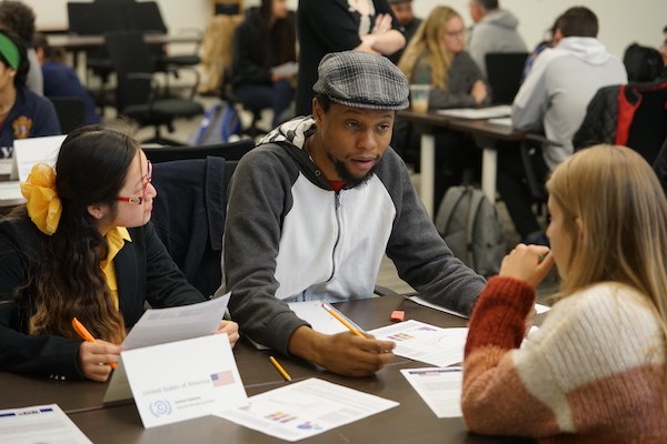 Student Javon Bryan takes part in the World Climate simulation with other students