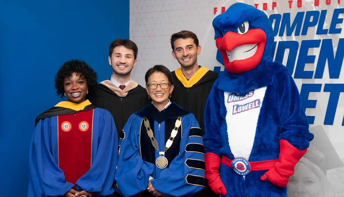 Abby Cooper poses with Chancellor Julie Chen, two students and UMass Lowell mascot Rowdy the River Hawk at Convocation.