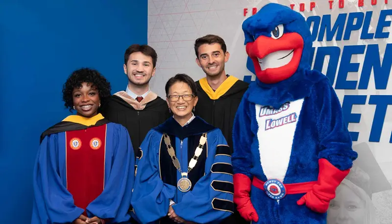 Abby Cooper poses with Chancellor Julie Chen, two students and UMass Lowell mascot Rowdy the River Hawk at Convocation.