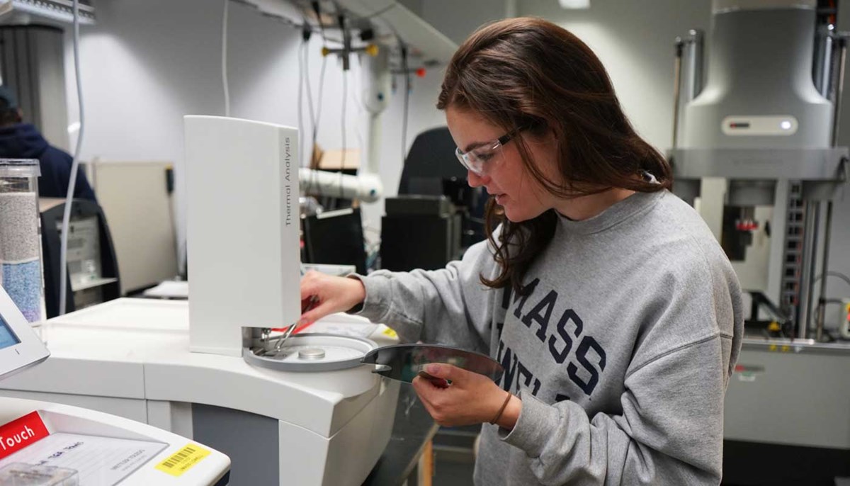 Abby Mastromonaco working with equipment in a plastics engineering lab at UMass Lowell  