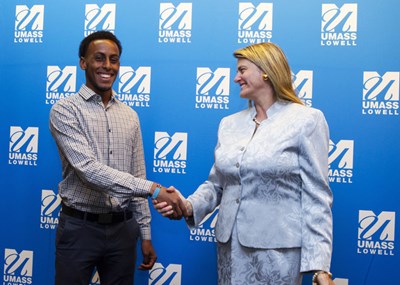 Abdi Shariff-Hassan shakes hands with Bonnie Comley