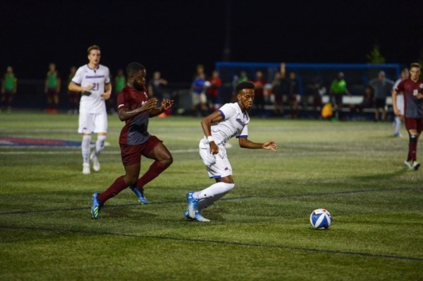 Abdi Hassan-Shariff playing soccer for the UMass Lowell River Hawks