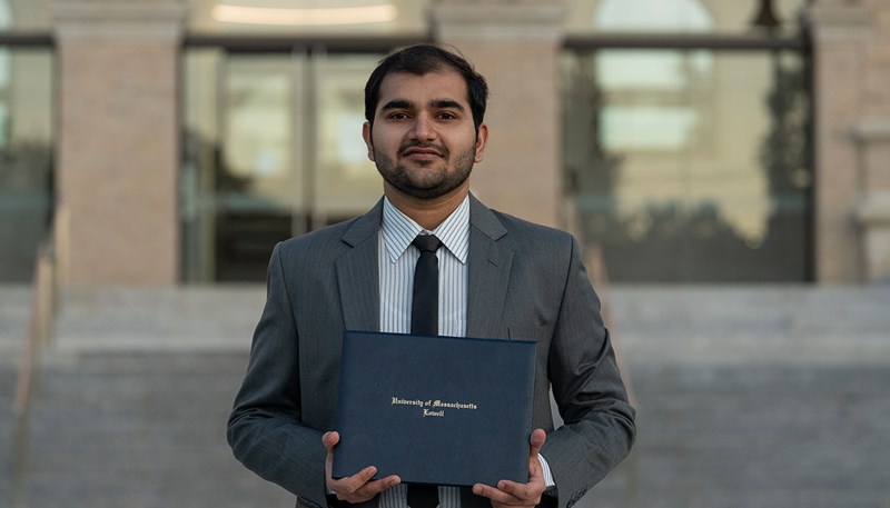 Abdul Hameed holds up his diploma