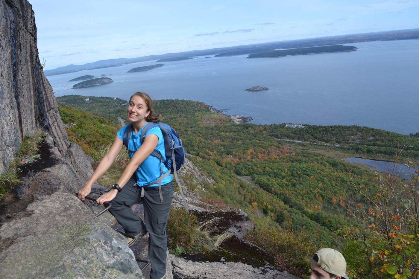 Student posing on Acadia hiking trip in fall.