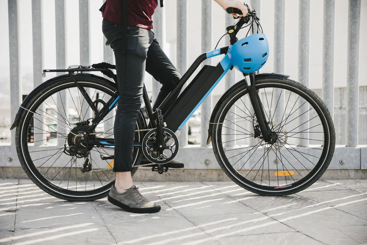 Urban cyclist taking a brake on e-bike (electric bike).