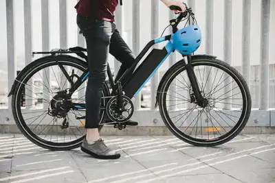 Urban cyclist taking a brake on e-bike (electric bike).