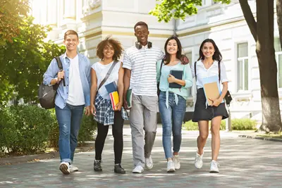 Group of college students smiling while walking and conversing