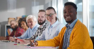 Staff in office around table