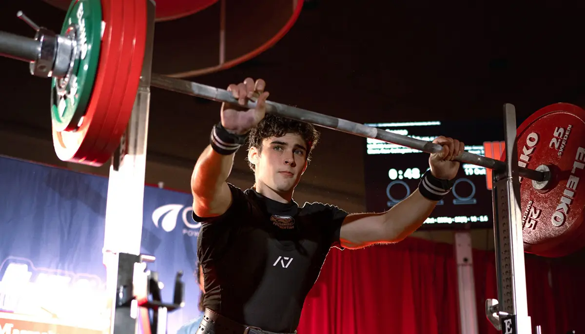 Aidan George lifting a barbell as part of the UMass Lowell Powerlifting Club.