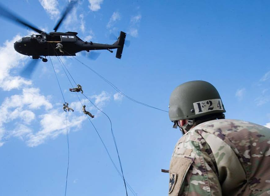 Cadets rappelling from a helicopter