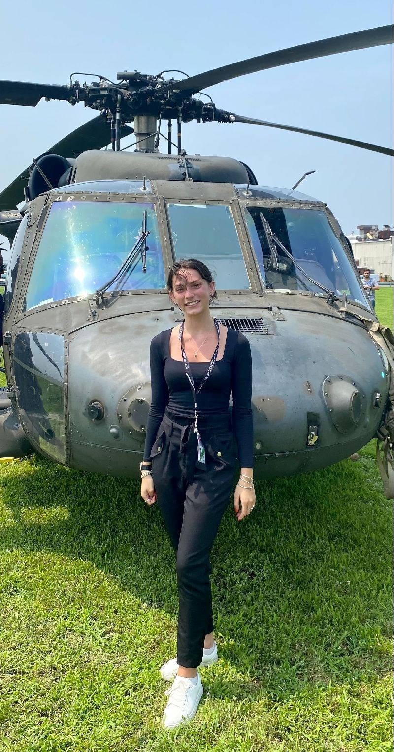 Alinna Hanna in front of a helicopter