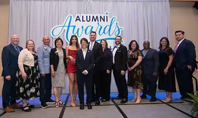 Photo of the 2026 UMass Lowell University Alumni Award winners with members of university leadership