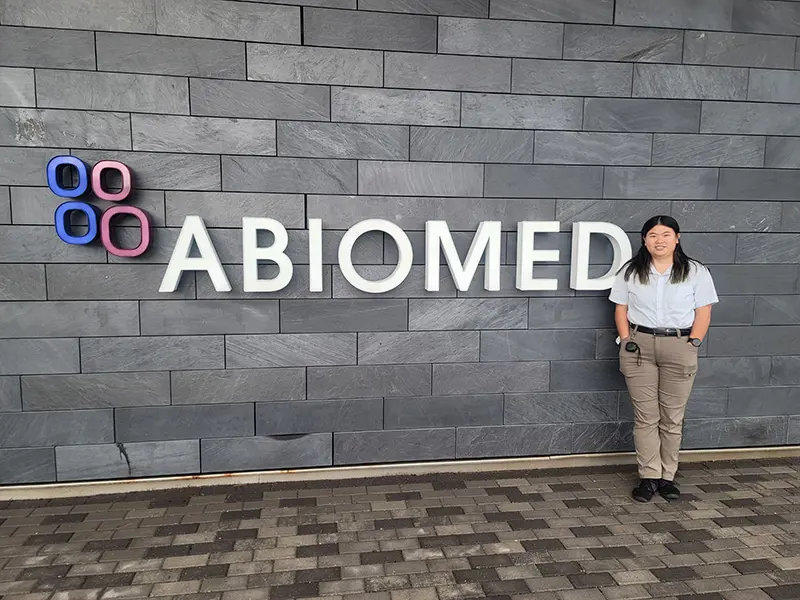 Anna Schmidt in front of Abiomed sign.