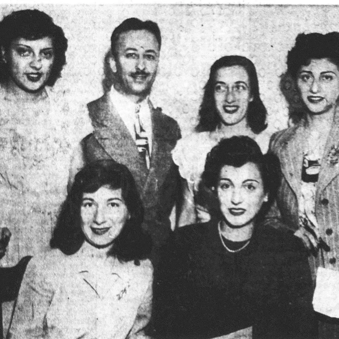 Six people in an old newspaper photo.