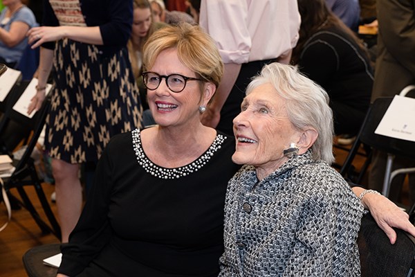 UMass Lowell Chancellor Jacquie Moloney and philanthropist Nancy L. Donahue laugh at a video