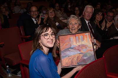 Art student Brooke Gibbas presents one of her paintings to Nancy L. Donahue at the Celebration of the Arts in 2022