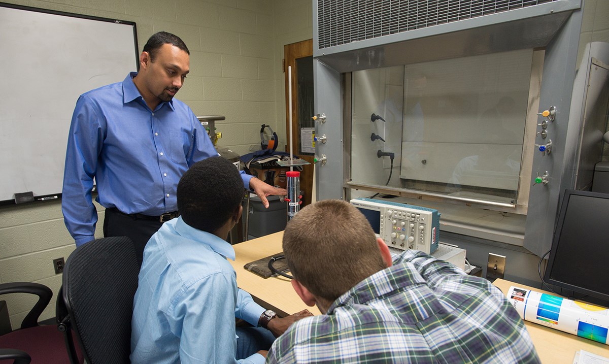 Associate Prof. Sukesh Aghara talking to two students somehwere inside the Nuclear Reactor.