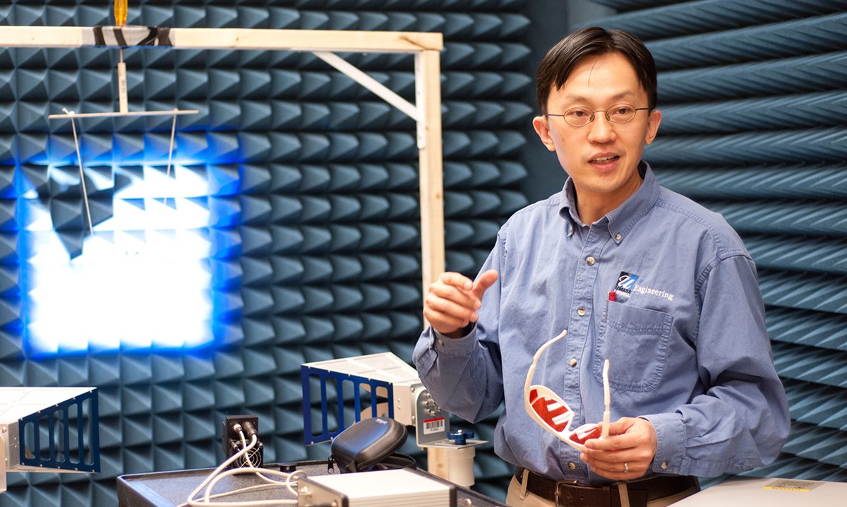 Associate Professor TzuYang Yu holding goggles and teaching