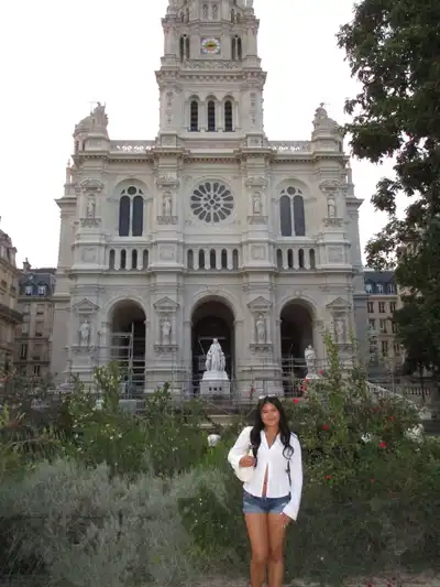 Atianna Noeuk stands in front of the Église de la Sainte-Trinité in Paris.