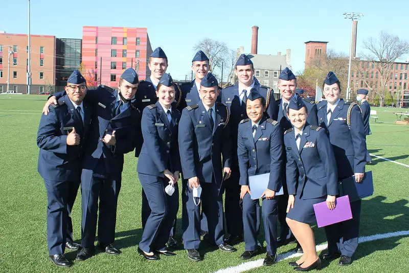 Cadets in 2020 hold their certificate awards while posing for a photo.