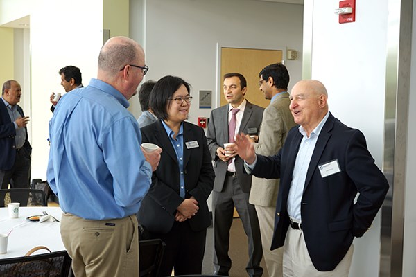 Manning School faculty members chat during the workshop
