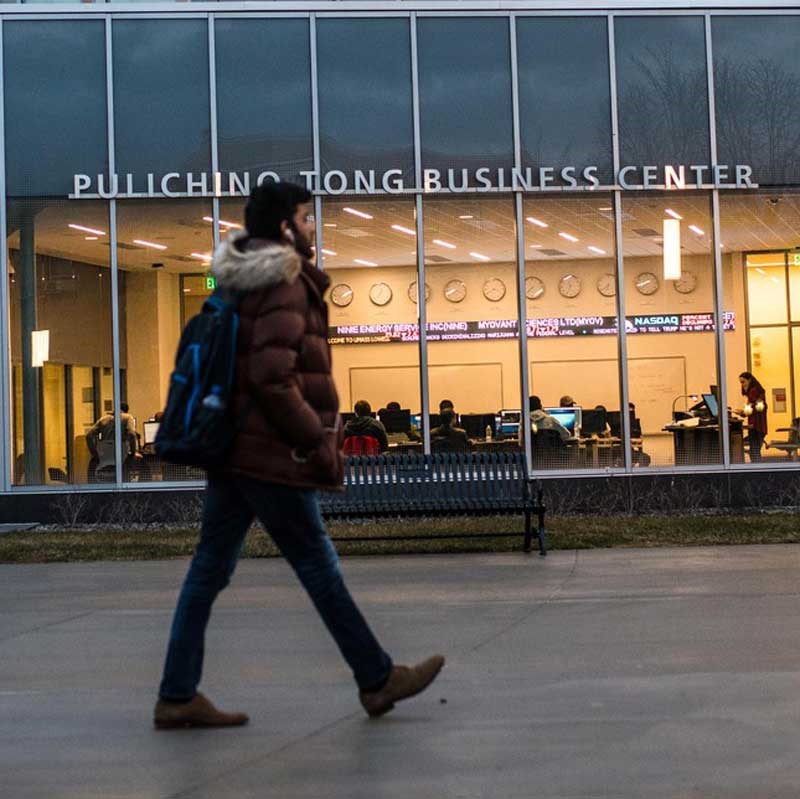 Student walks in front of the Tong Business Center at UMass Lowell