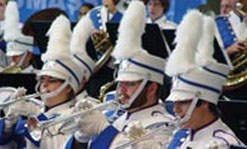 umass lowell's band participating at an event, playing the trumpet and tubas.