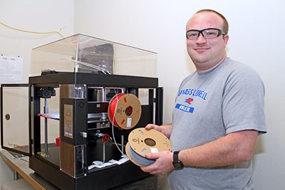 George Barlow uses a RAise3D Pro3 printer in a lab.