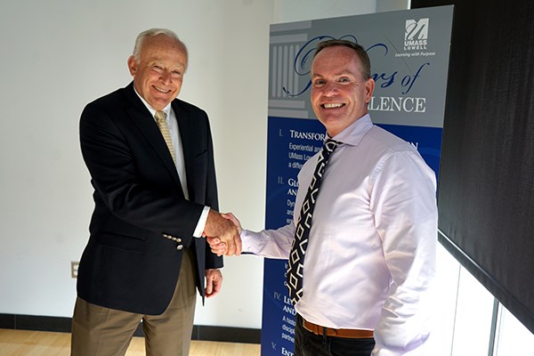 Paul Keyser shakes hands with John Doleva