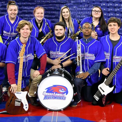 This image is of the Basketball Pep Band, which performs at all men’s and women’s home basketball teams. Pictured are 8 members of the rhythm section and wind players. This group is open to all students at the university. Clicking here will take you to the webpage for the band.