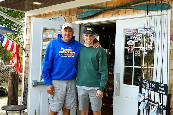Ben Kenney and his dad Daniel pose outside the tackle shack