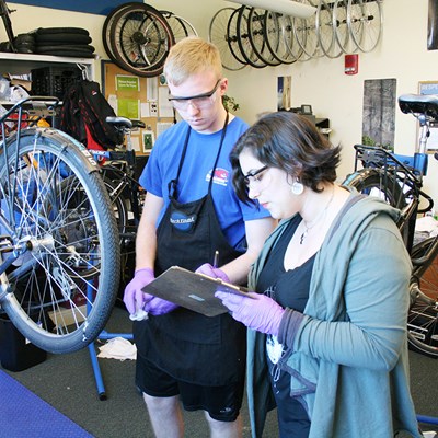 Woman filling out work order in bike shop