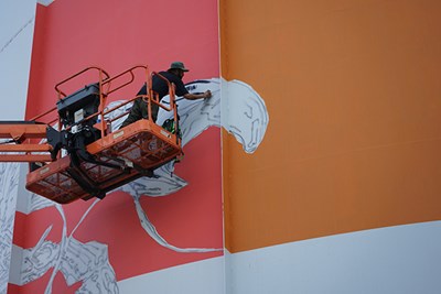Internationally known muralist "Bikismo" working on "Chrome Cobito" at UMass Lowell
