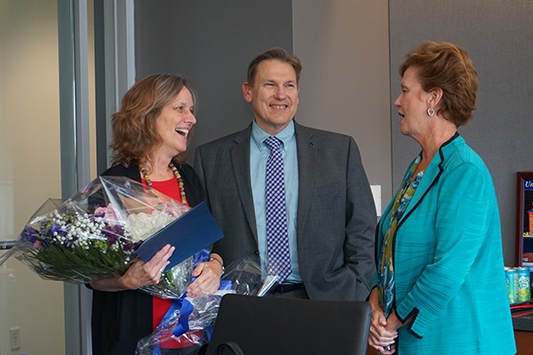 Meg Bond was named 2018 University Professor in a surprise ceremony at the chancellor's office. She was congratulated by Provost Michael Vayda and Chancellor Jacquie Moloney.