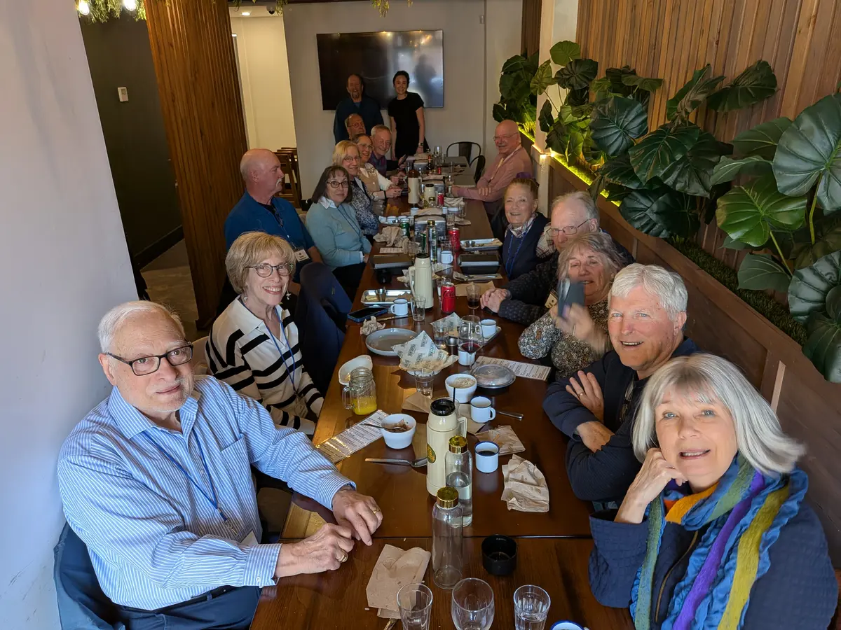 Learning in Retirement Association (LIRA) members seated at the table at Tren Caipira, Lowell.