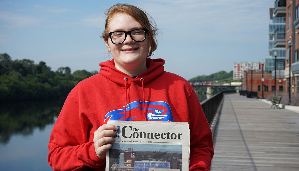 Brigid Archibald holds up copy of The Connector