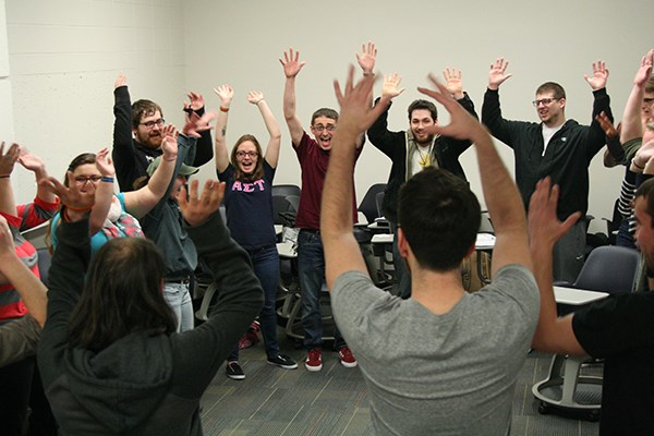 Students warm up with an improv exercise before making their pitches