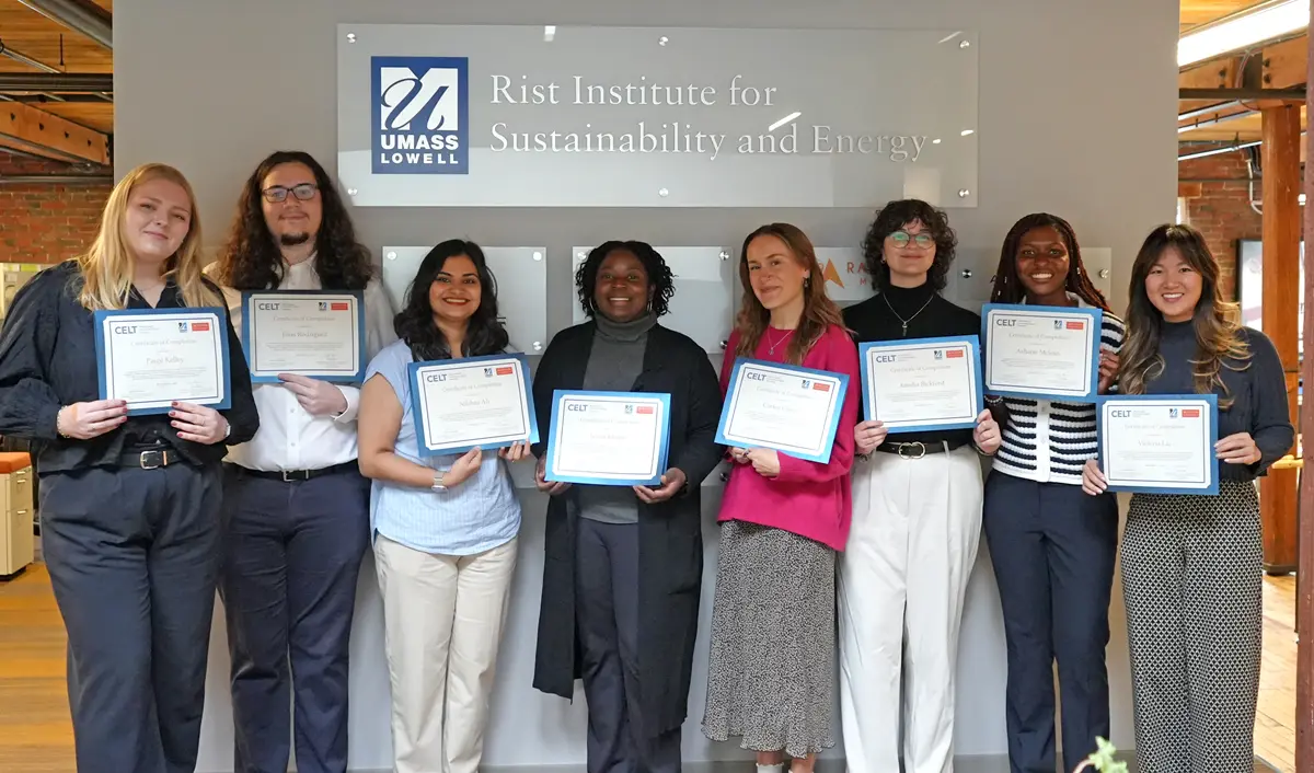 Eight municipal fellows hold up certificates for completing the program.