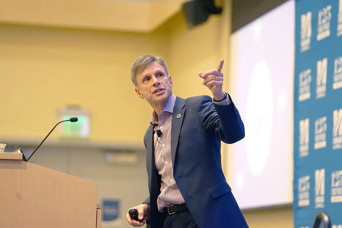 Chris Laszlo on stage speaking