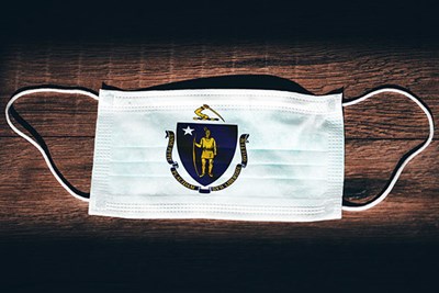 White face mask with Massachusetts state seal on it