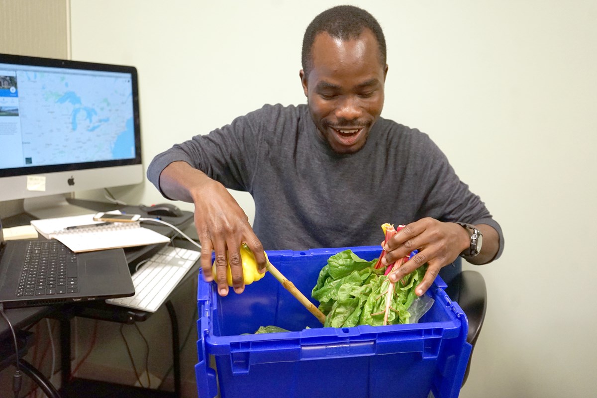 A student looks at the vegetables in his bin